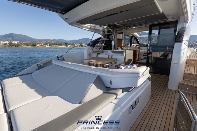 Luxurious 2019 Princess S60 yacht cruising swiftly on open water.