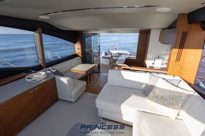 Luxurious 2019 Princess S60 yacht cruising swiftly on open water.