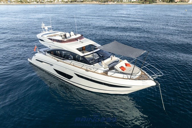 Luxurious 2019 Princess S60 yacht cruising swiftly on open water.
