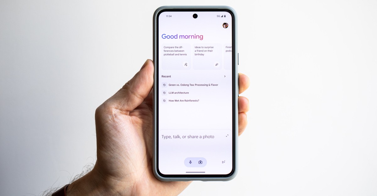 Phone in hand showing Google Gemini welcome screen.