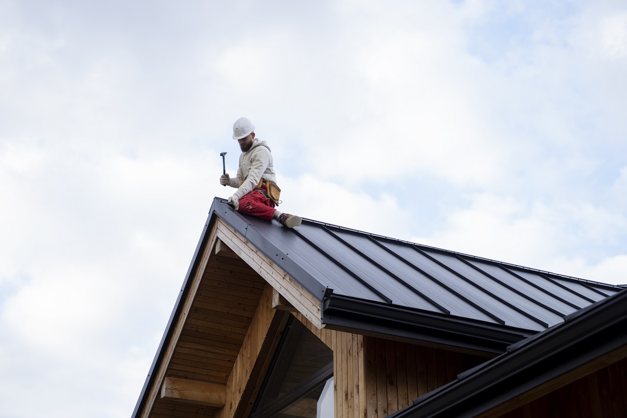 Full shot man working roof