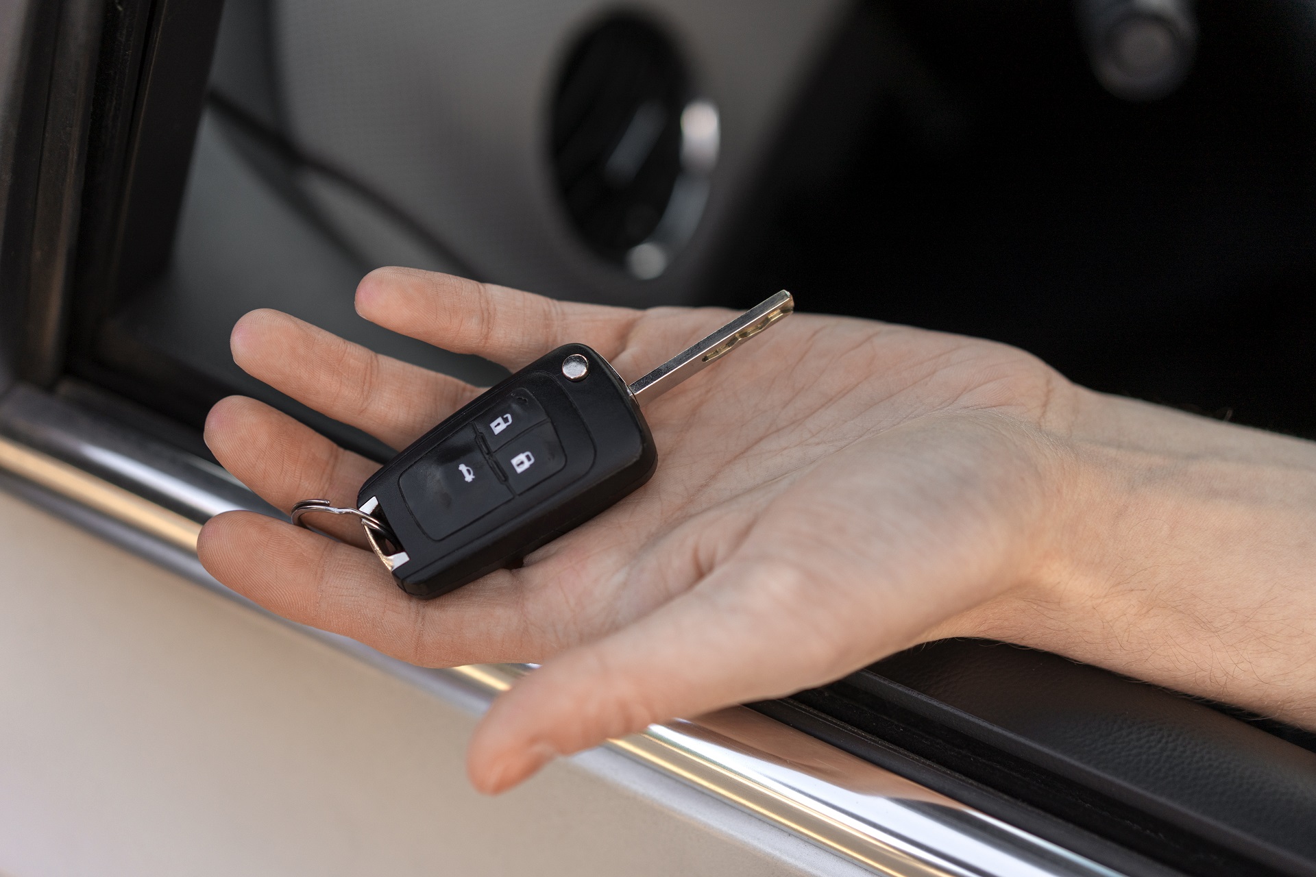 High angle hand holding car key