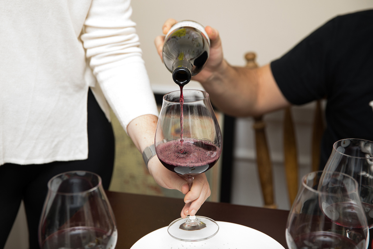 Beaujolais being poured into a burgundy glass