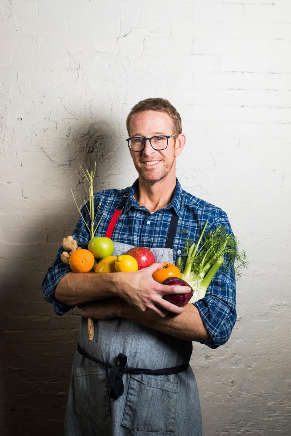 Chef CJ Jacobson holding vegetables