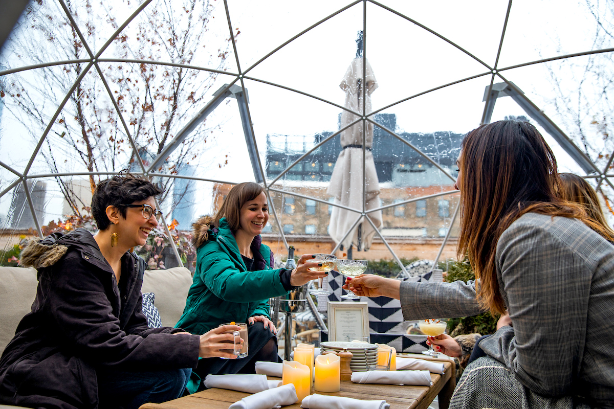 guests cheersing inside igloo