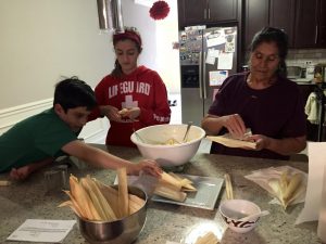 Family making tamales - holiday food traditions