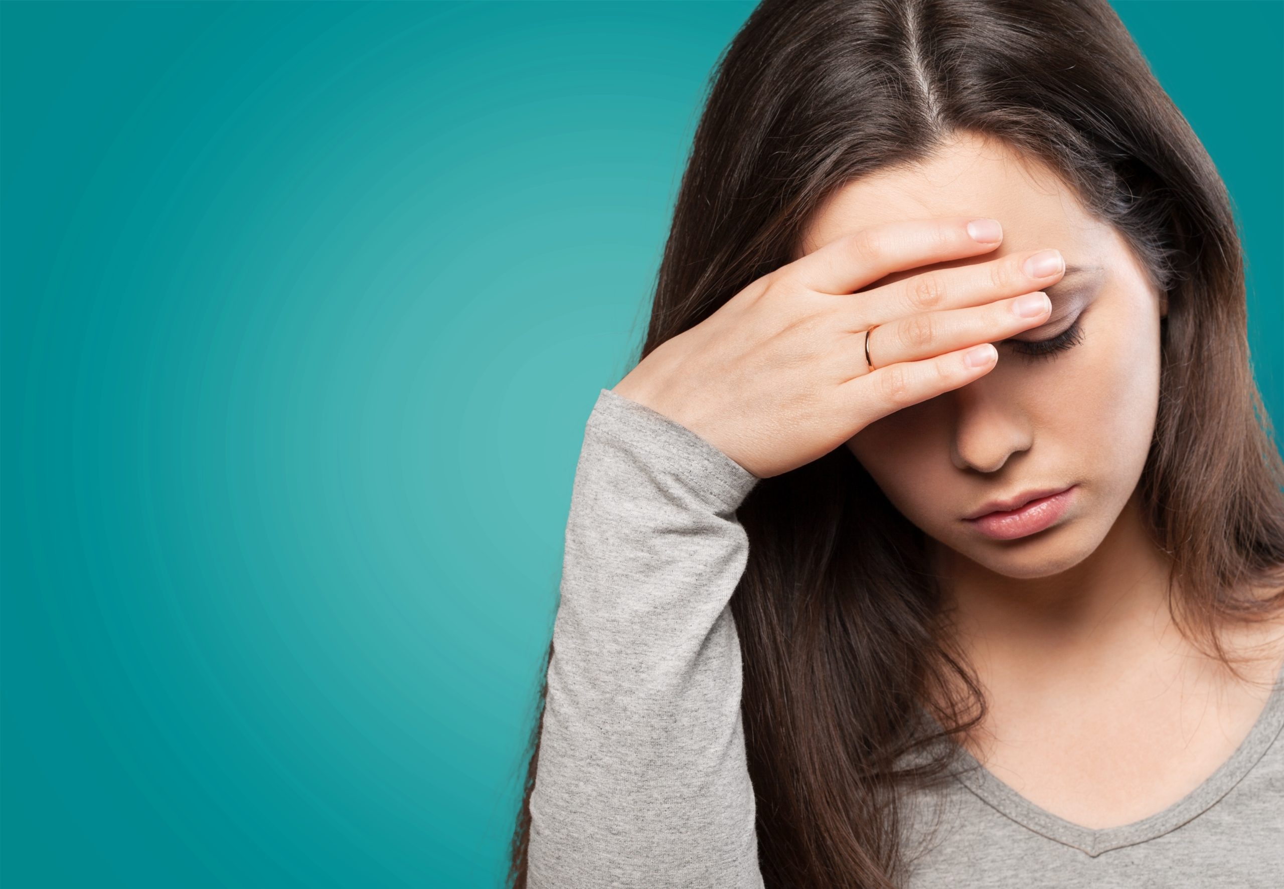 Brunette woman with anemia not feeling well.