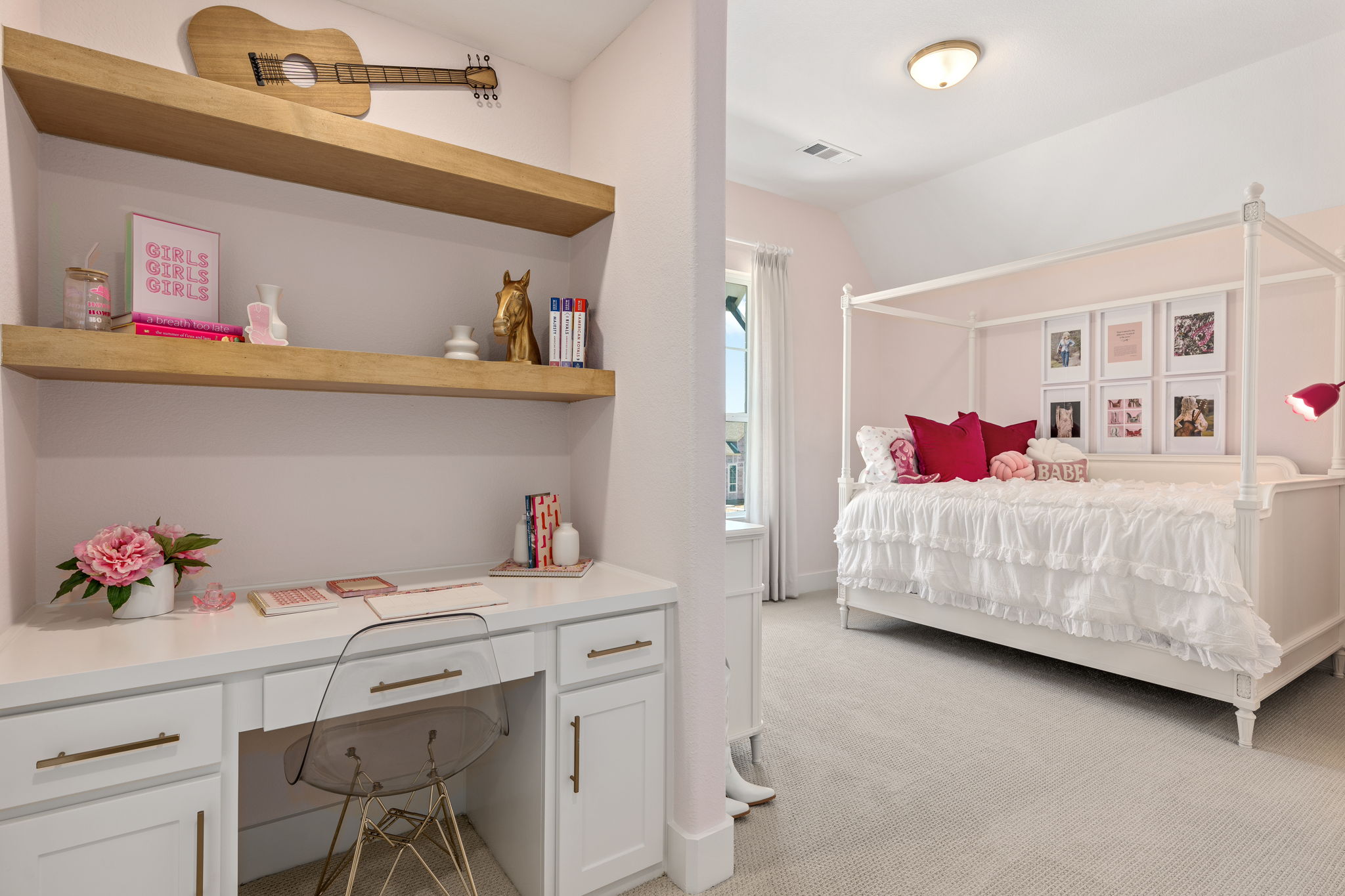 Girls' bedroom with light pink accents and a built in desk.