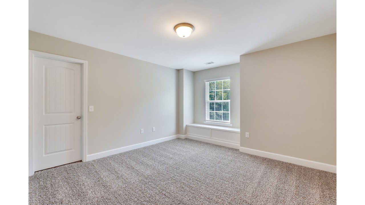 Window seat with built-in storage in an Ernest Homes bedroom