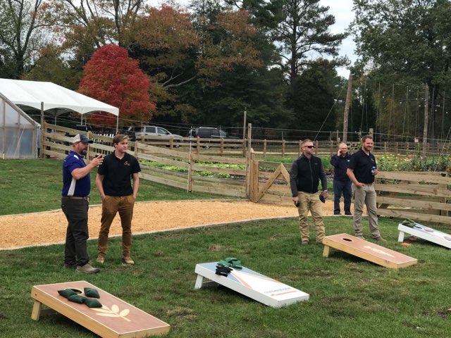 People playing cornhole.