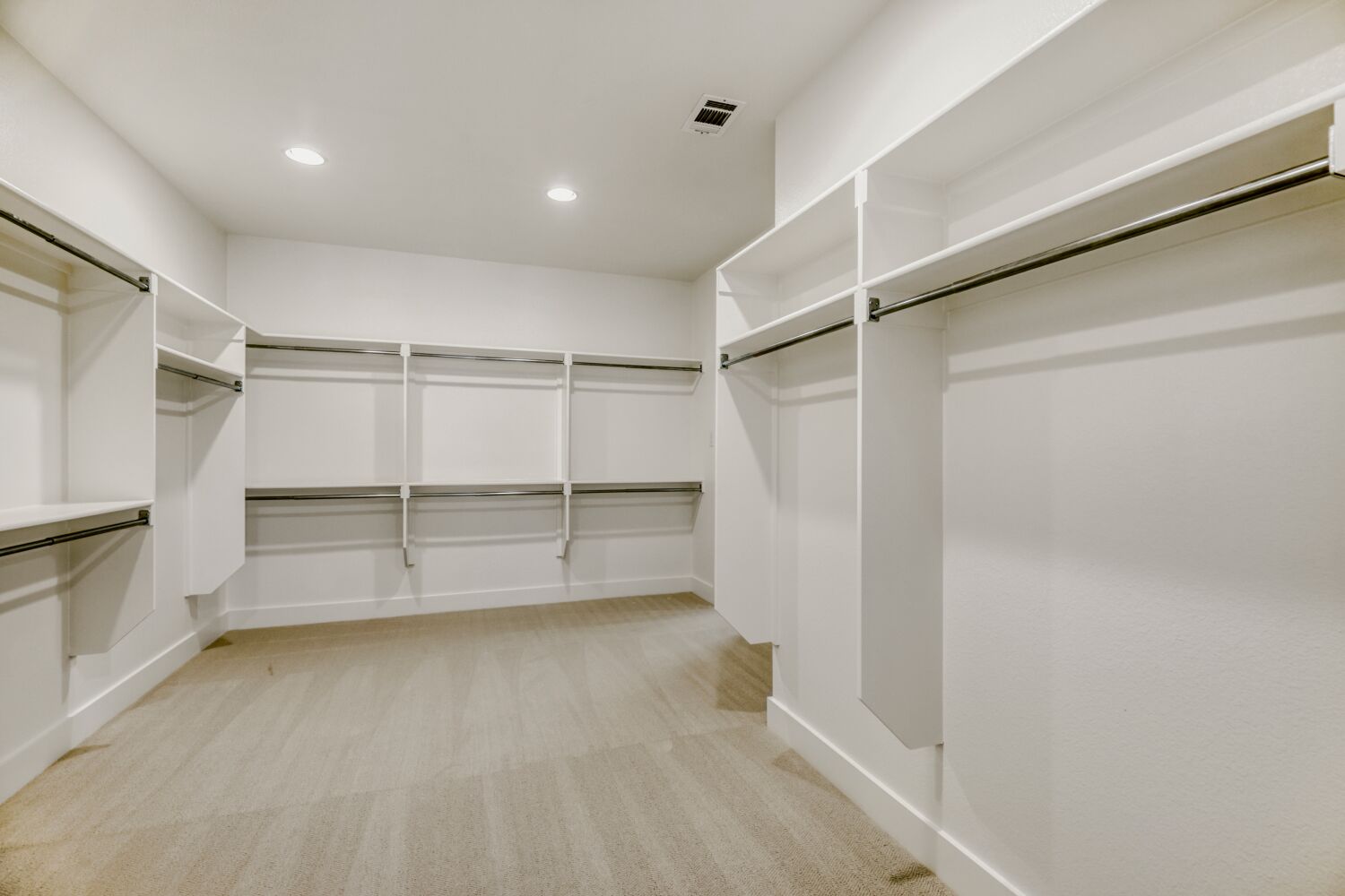 Spacious walk-in primary closet with automatic lights