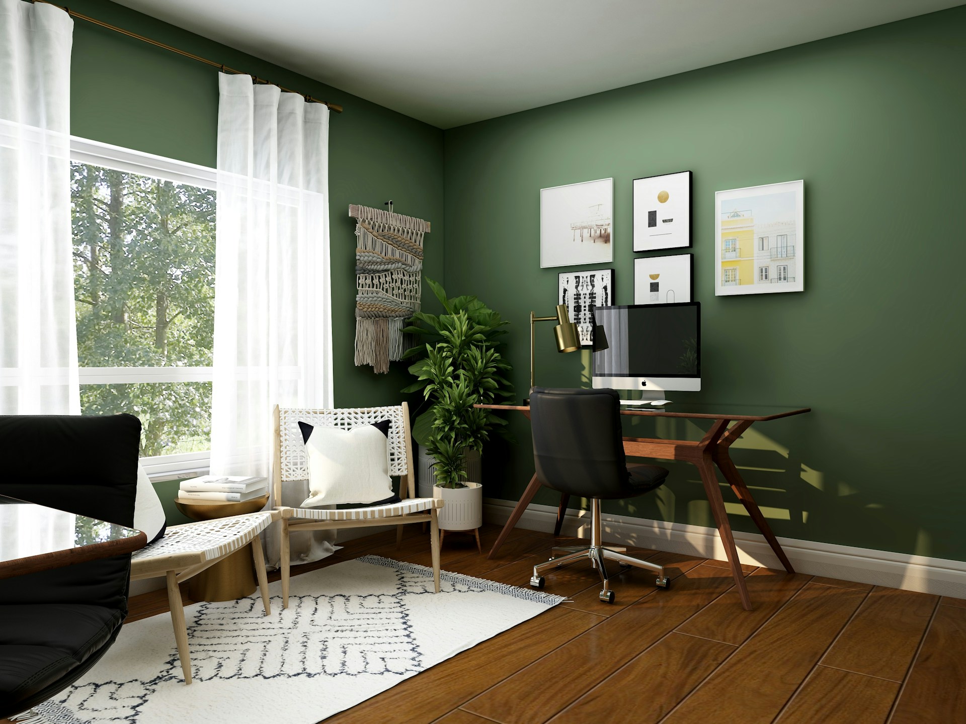 Modern home office with green walls, a wooden desk with a computer, a black office chair, white woven chairs, and large windows letting in natural light.