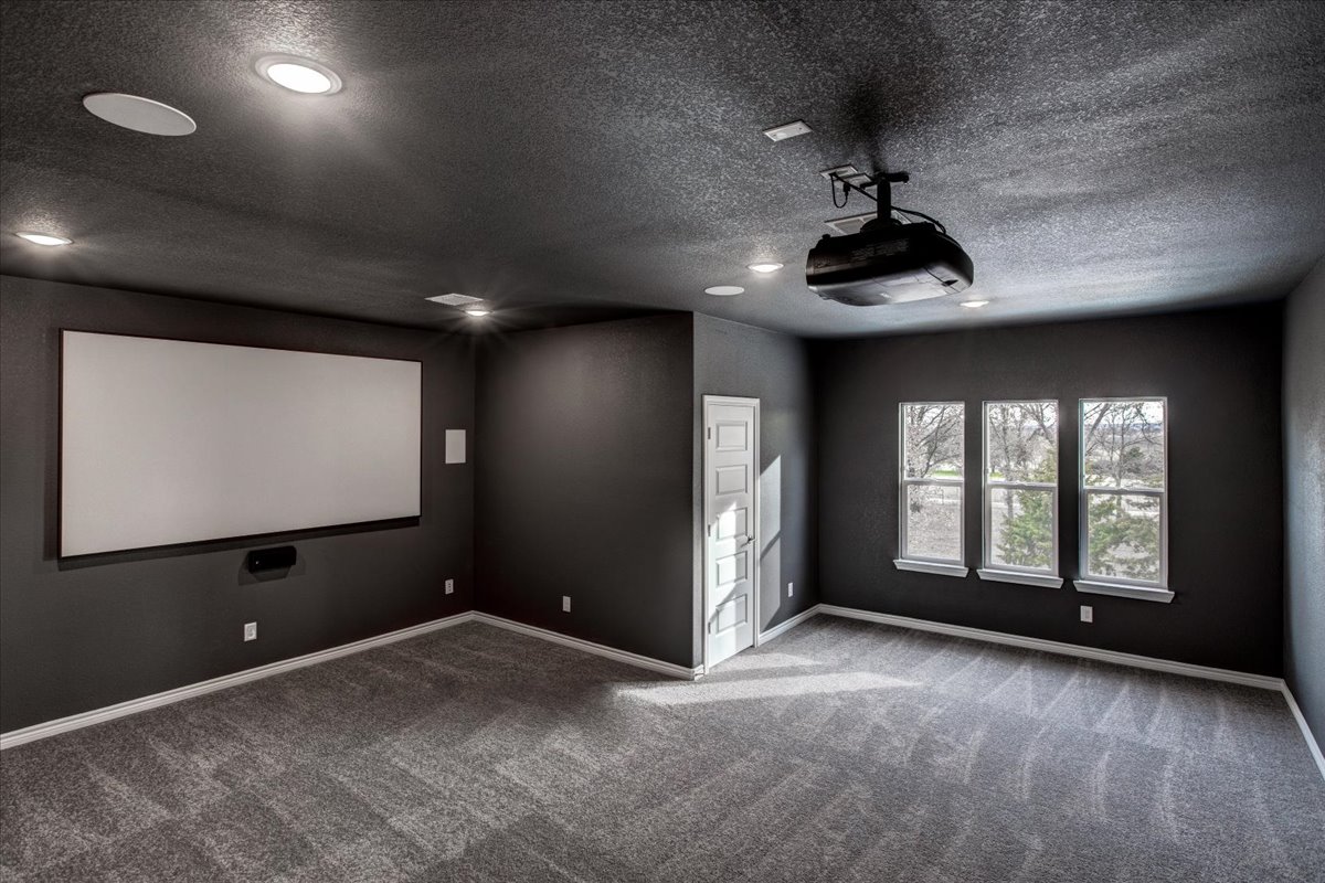 Media room with projector ready to use in the Springtown Build on Your Lot Project by Sandlin Homes.