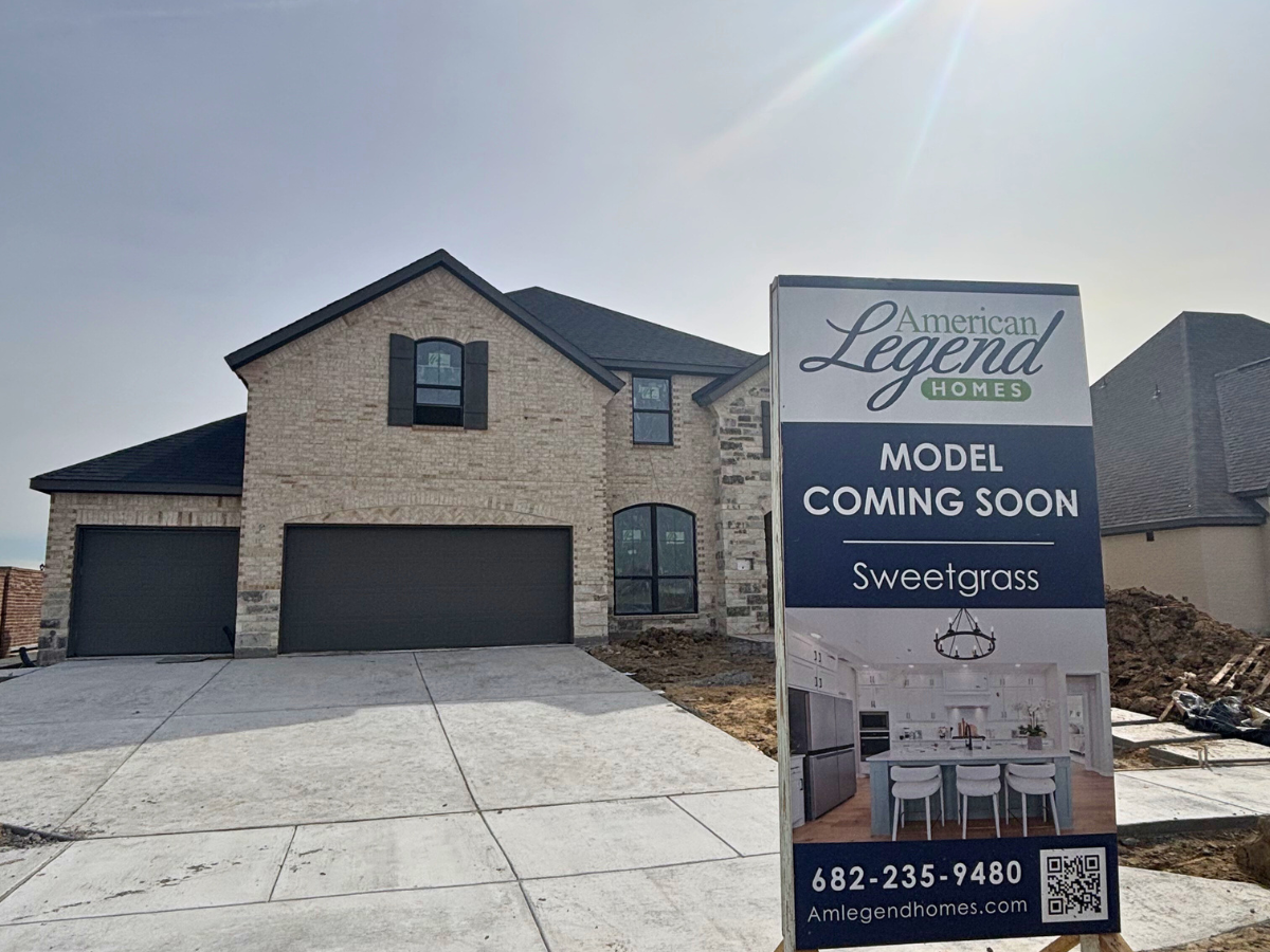 Exterior shot of a two-story home mid-build and during construciton.