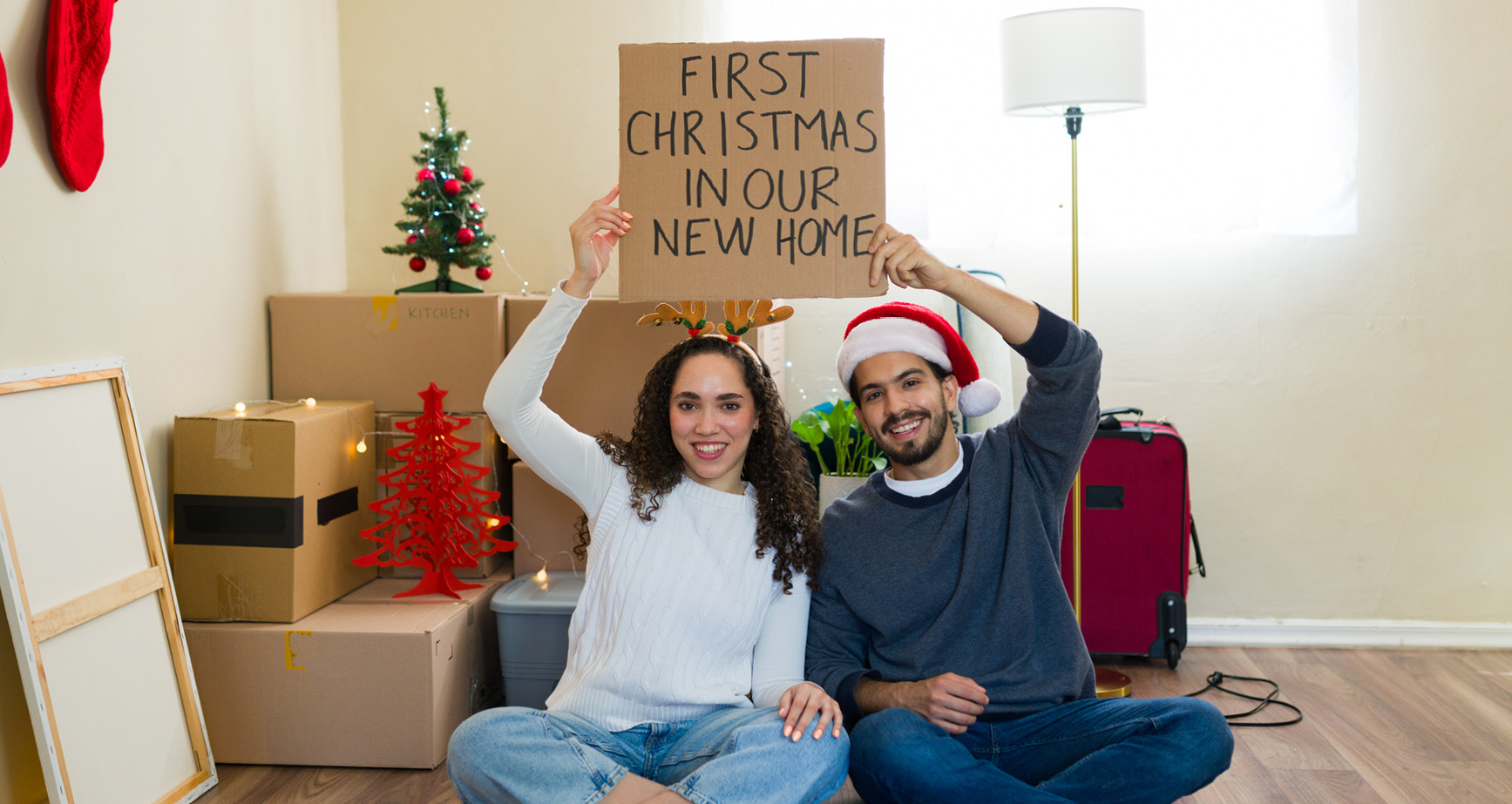Happy young couple in their new home by Kay Builders for the holidays