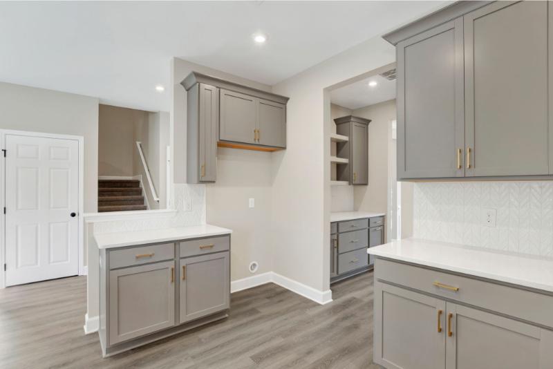 Kitchen at 245 James Drive in Richmond Hill GA featuring gray cabinetry, quartz countertops, and gold hardware