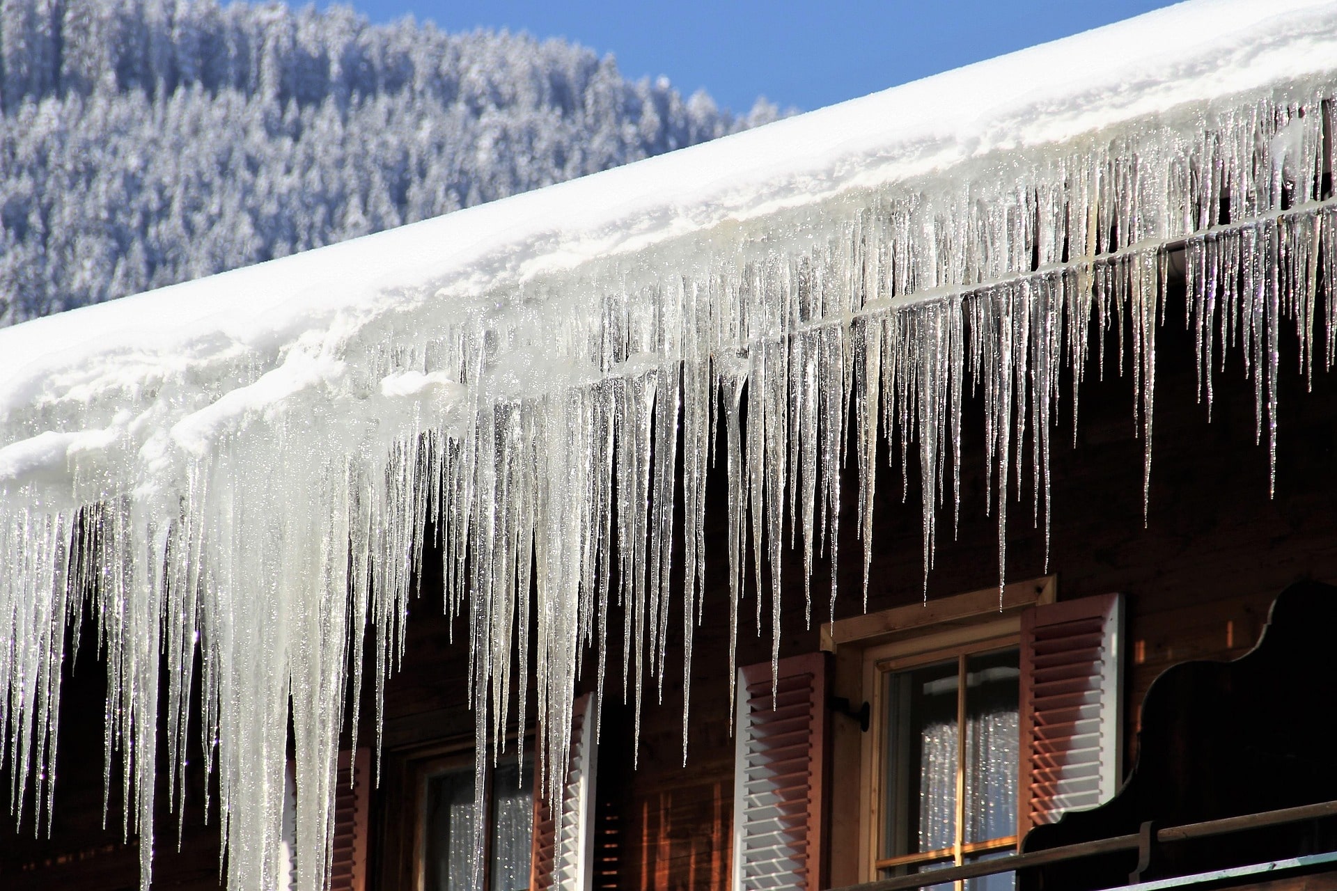 Gutters covered in snow with icicles