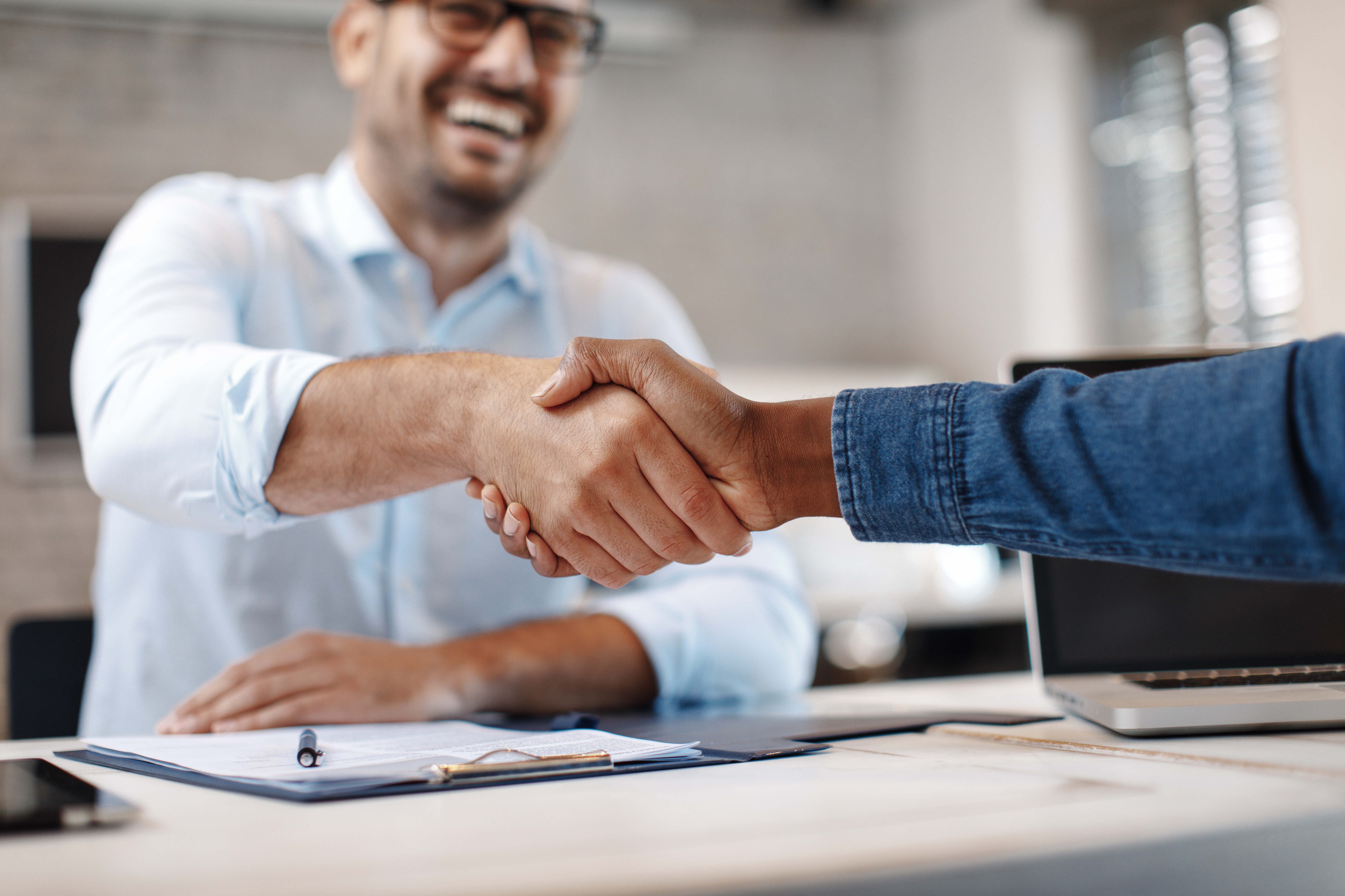 Homenuyer shaking the hand of a new home sales consultants | berks homes