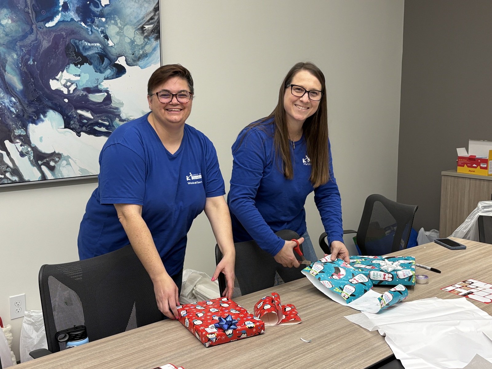 Two people wrapping gifts.
