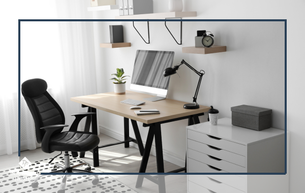 Ergonomic chair and desk setup in a modern home office with wood flooring.