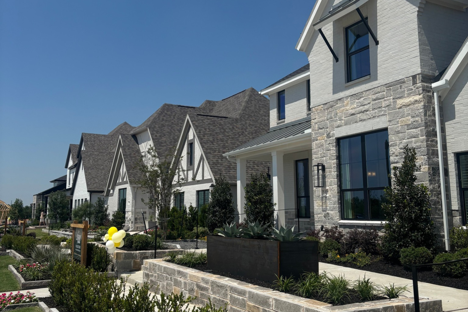 Images of gorgeous model home exteriors lined along the street