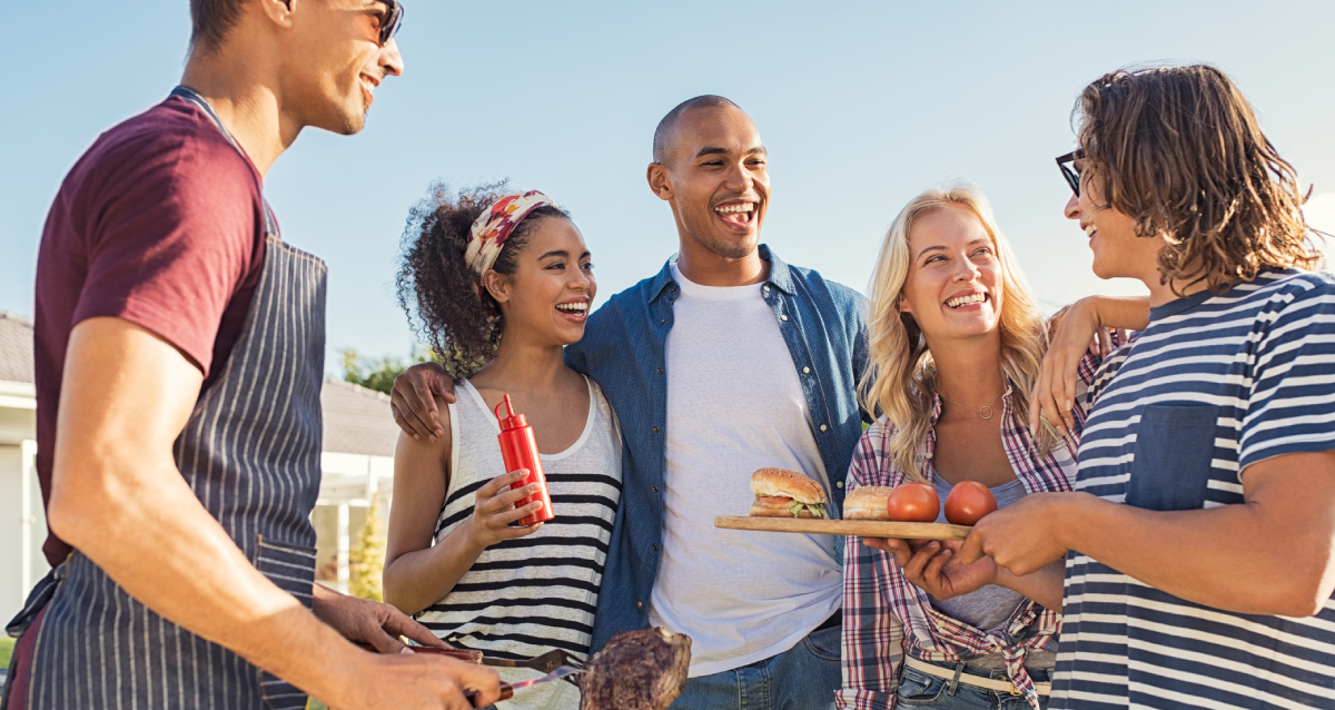 Five friends in a group at a tailgate.