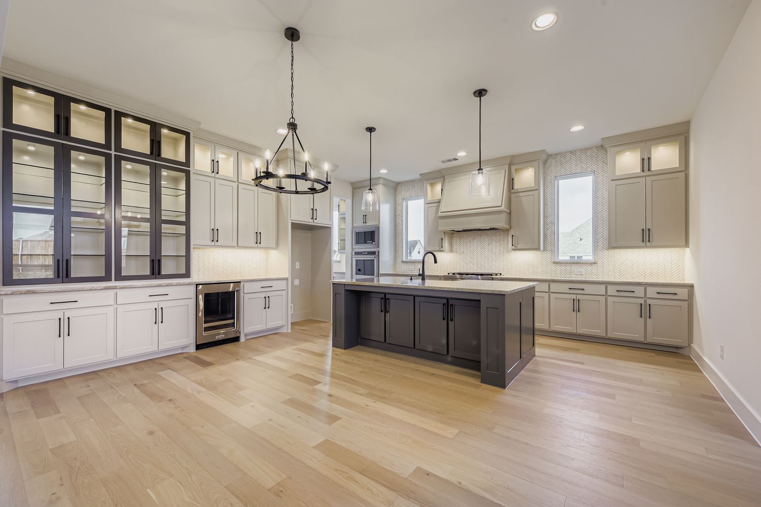 Interior of grand kitchen with extensive built-in cabinetry and upgraded oversized island