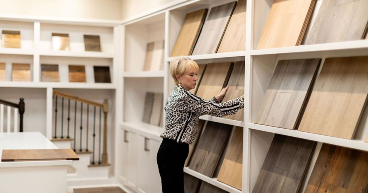 Smith Family Homes' in house designer Susan Brinkley organizing flooring samples in the design center.