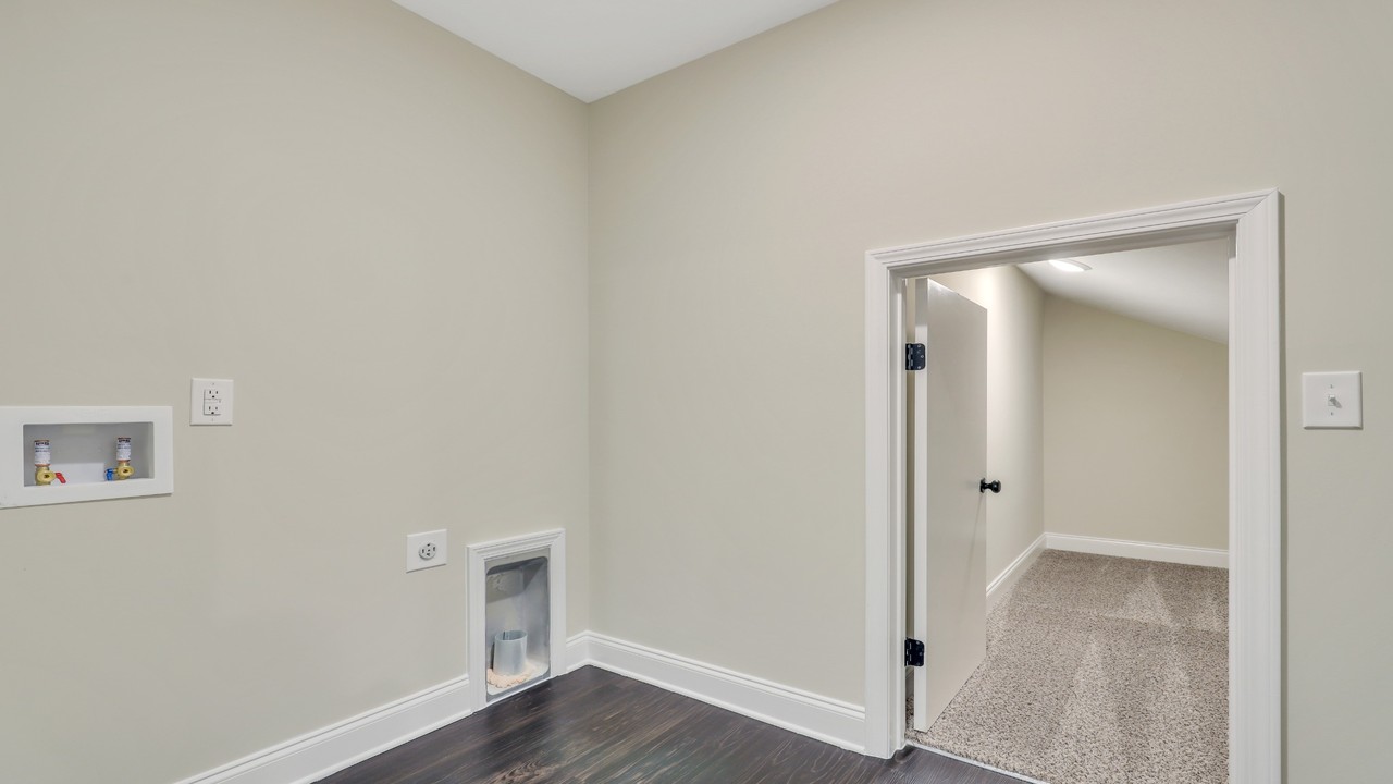 Finished attic storage space with flooring, drywall, and lighting in an Ernest Homes home
