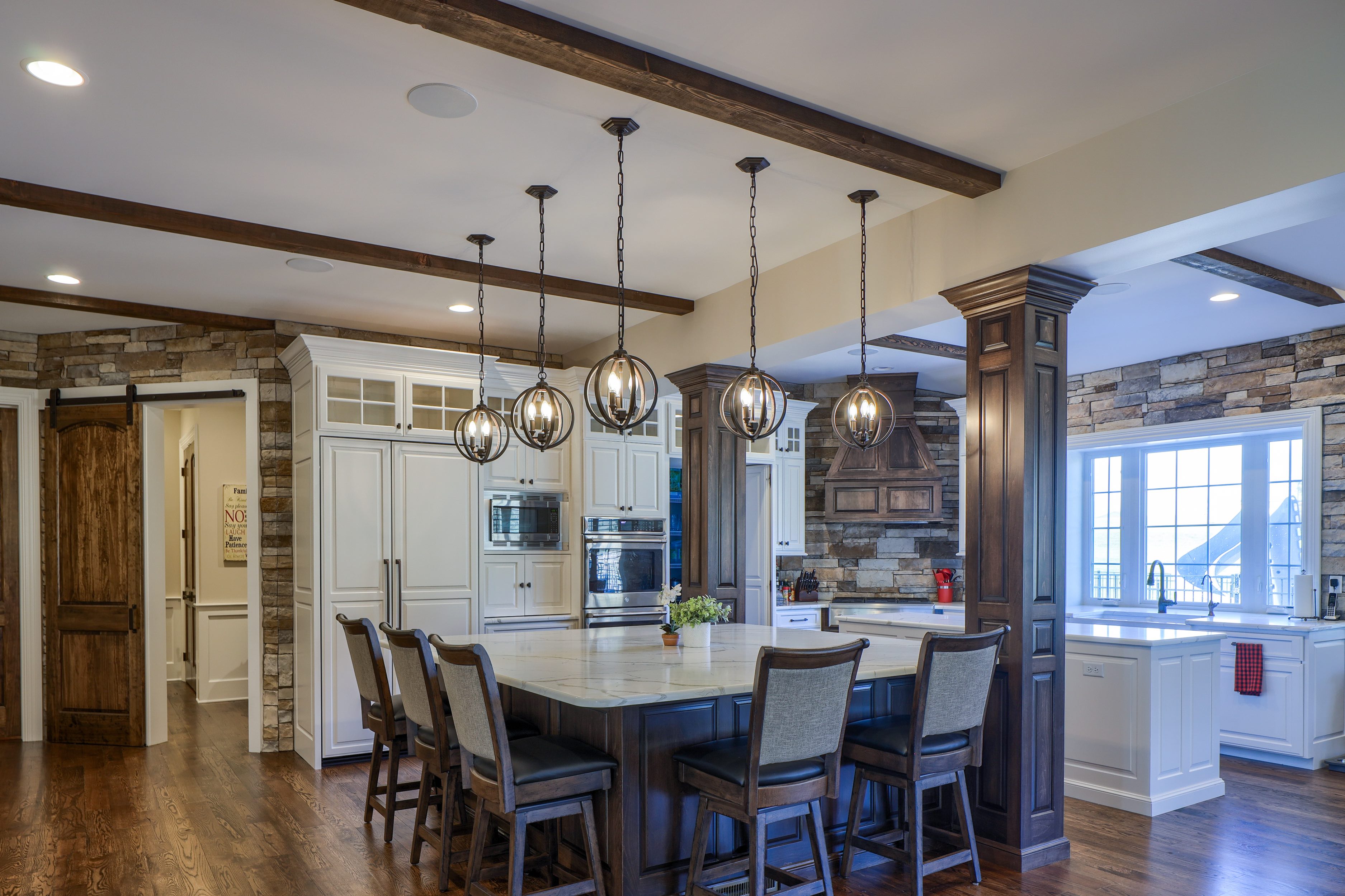 Large kitchen with white cabinets and two islands