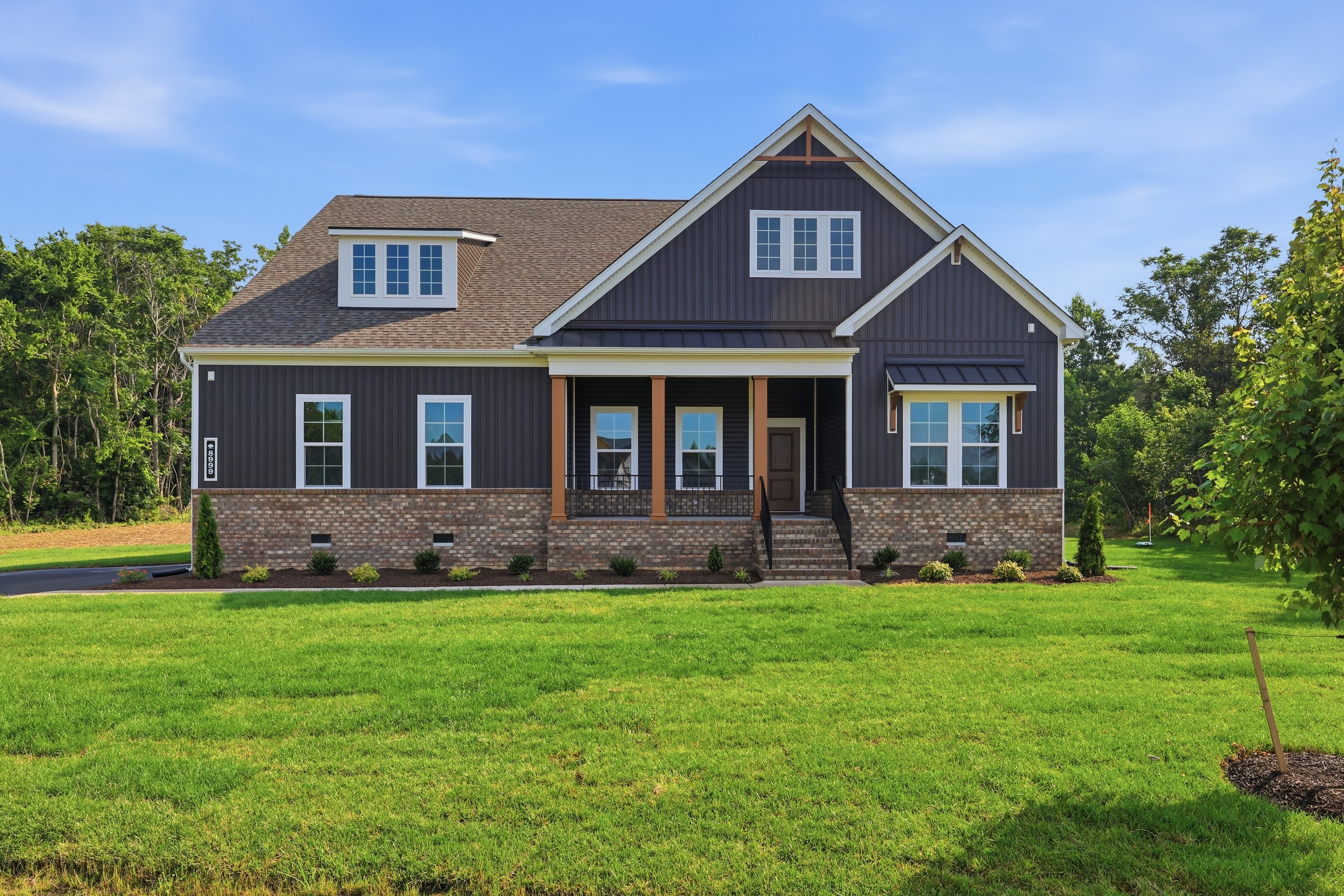 The Westmoreland home from StyleCraft homes. Green front lawn, blue sky.