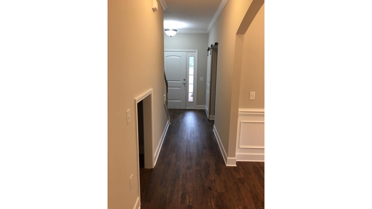 Under-stair pet room entrance in an Ernest Homes hallway