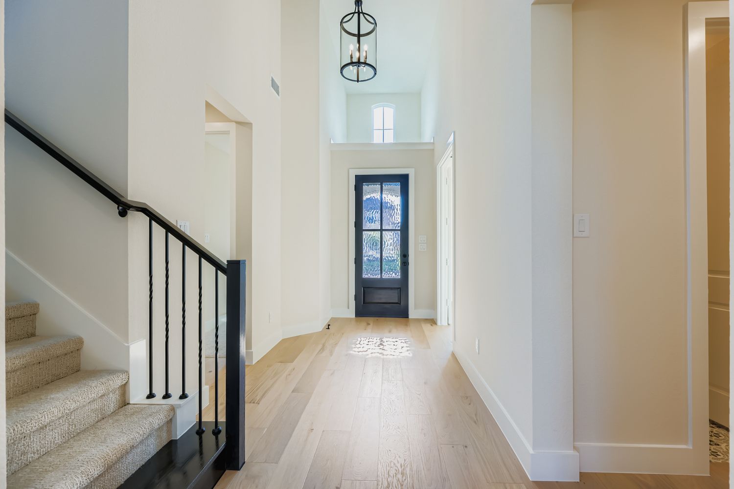 open foyer with chandelier and image of staircase
