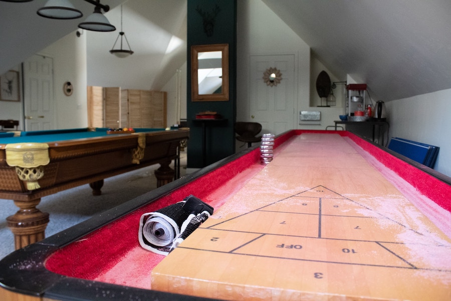 Entertainment Room With a Pool Table and Shuffleboard