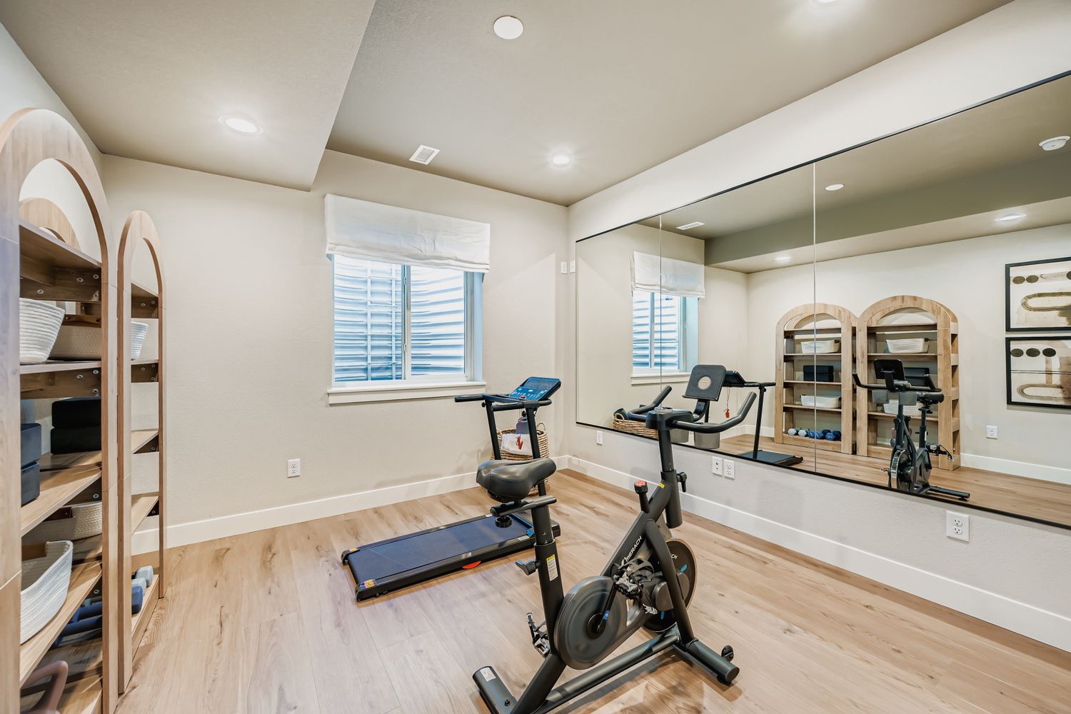 At-home exercise room complete with mirrored walls and fitness equipment