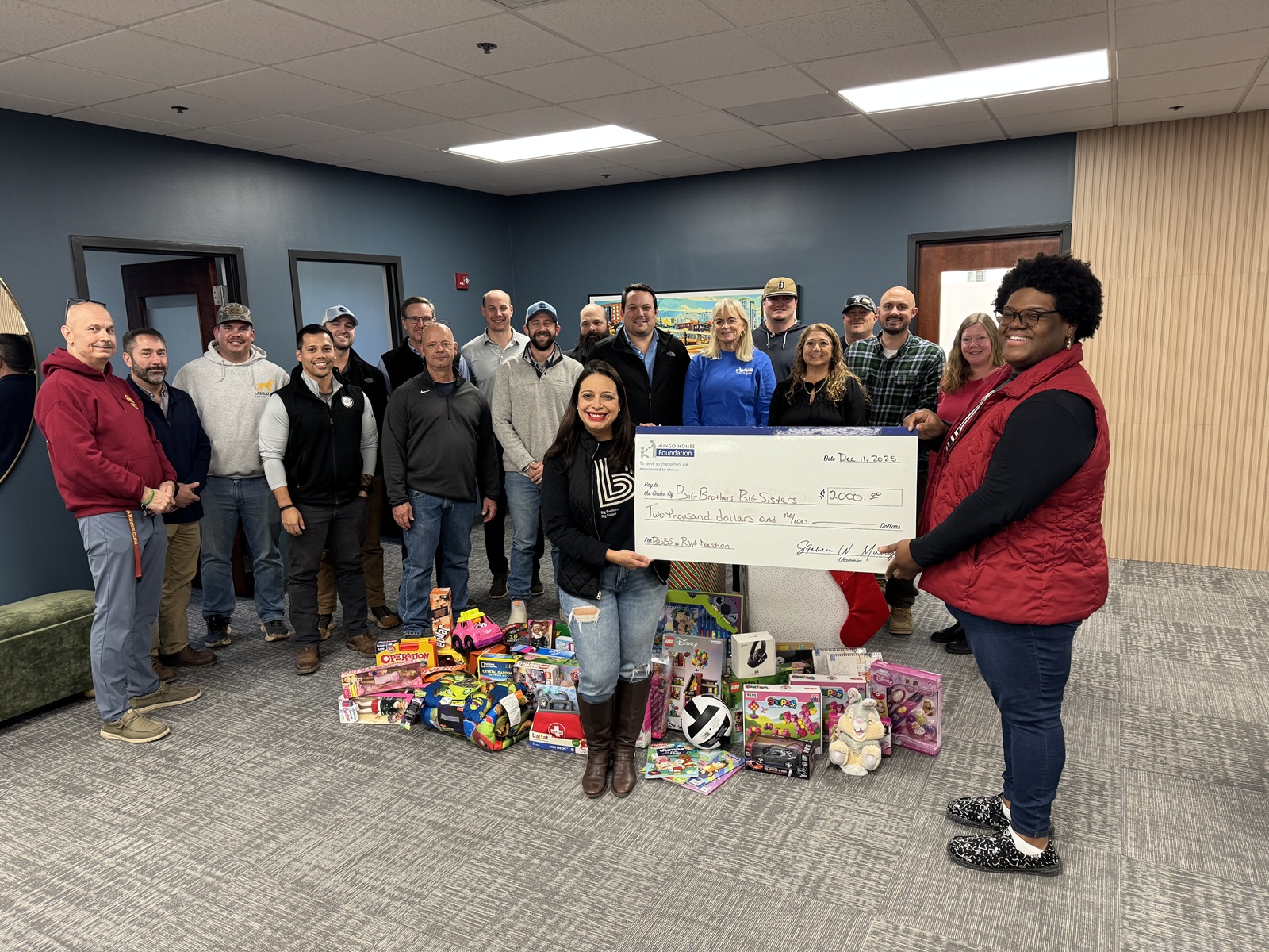 Mungo employees with a giant check for Big Brothers Big Sisters.