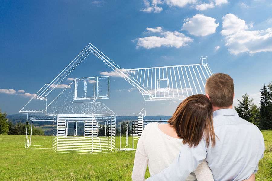 Loving young couple looking at dream house