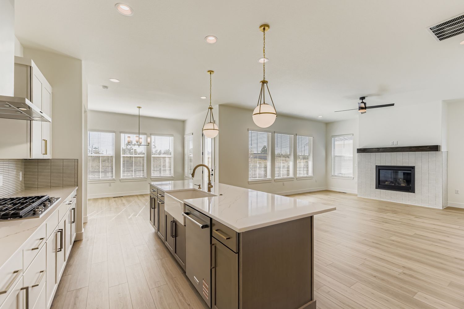 open-concept living area including kitchen, dining, and fireplace in the living room