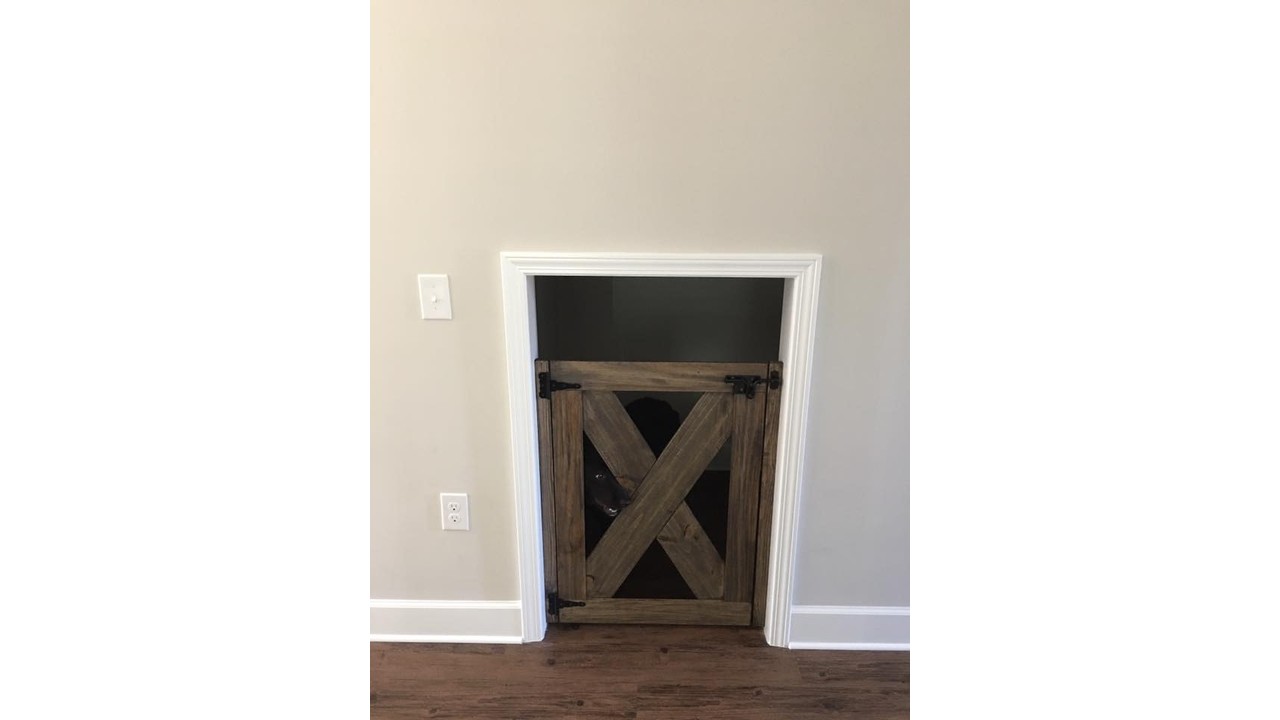 Built-in dog room under the stairs with barn door