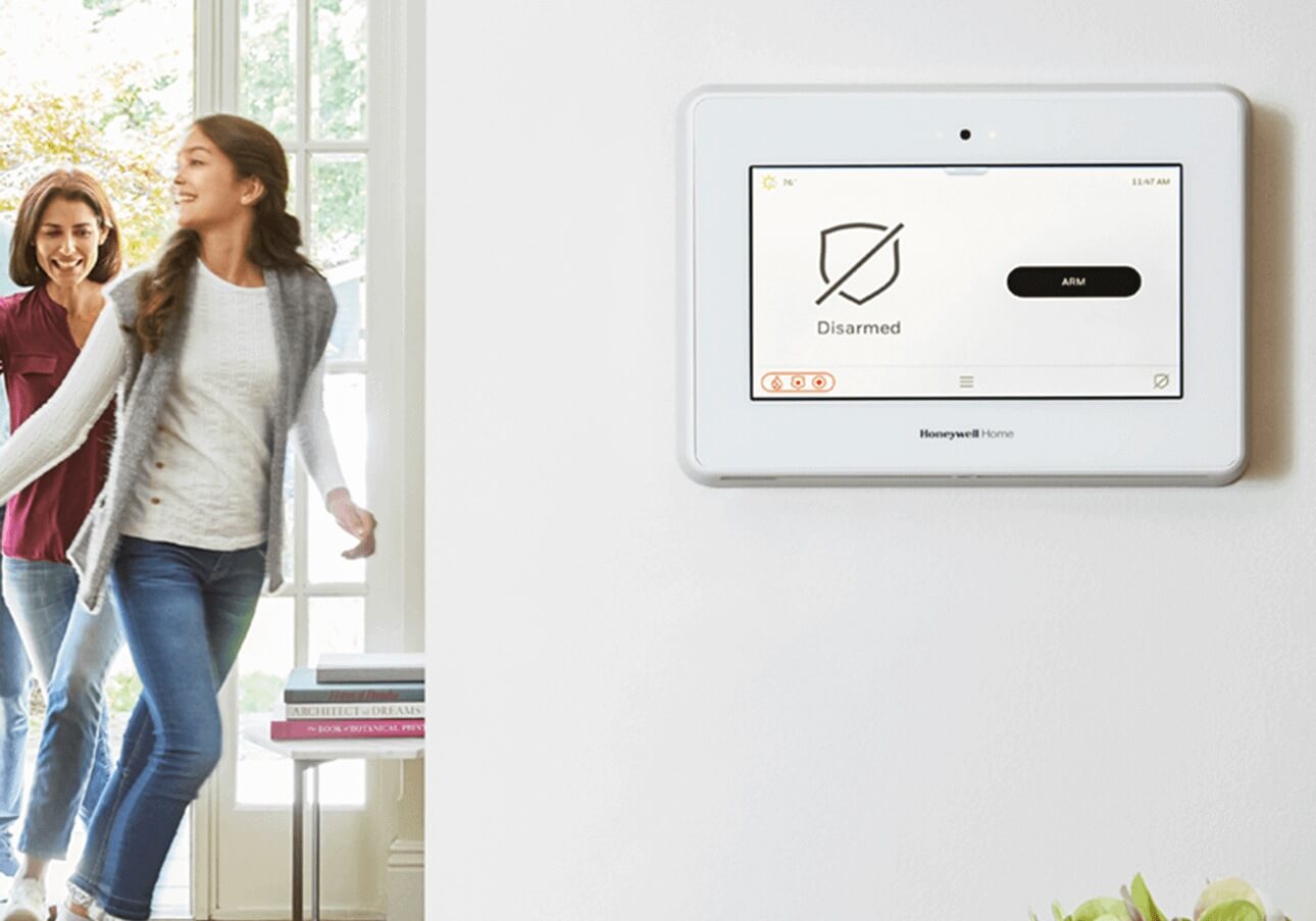 Mother and daughter enter the home, security system is shown disarmed