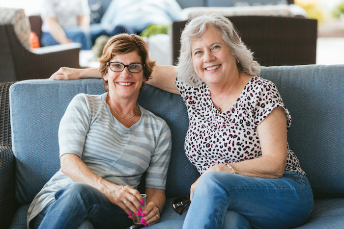 Women sitting on couch.