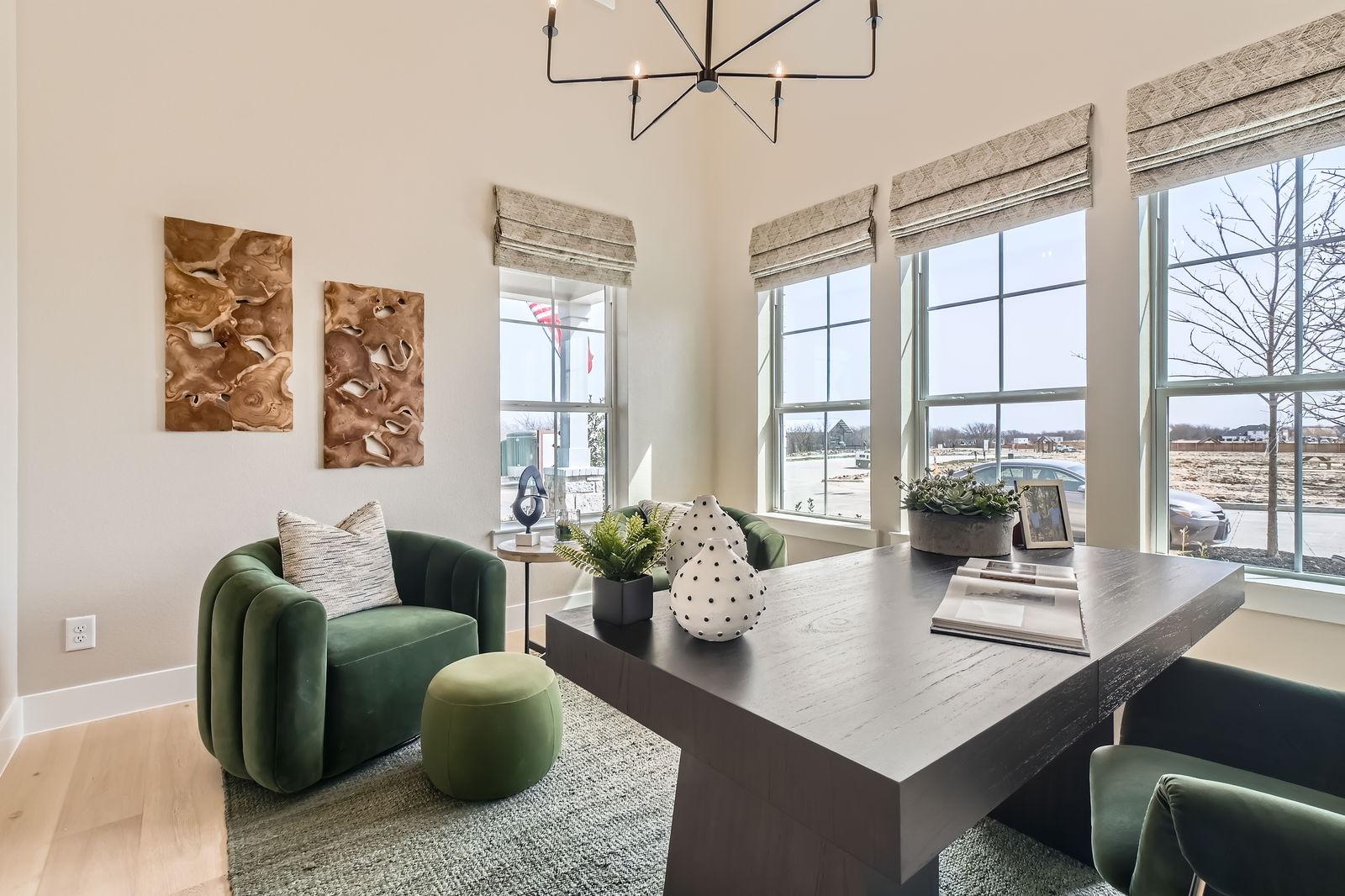 Elegant study with windows on two walls, and modern decor lighting fixtures and furniture