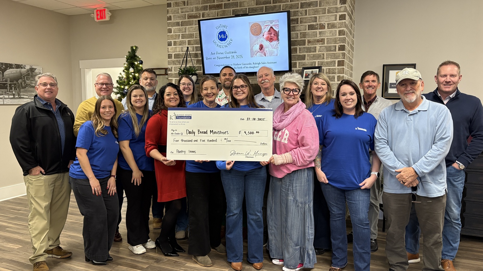 A group of Mungo employees presenting a check to Daily Bread Ministries.