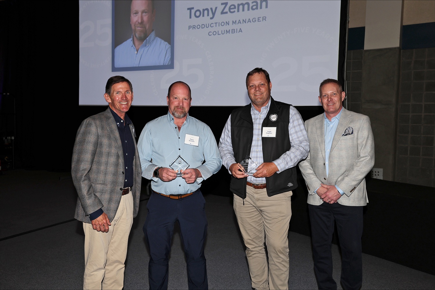 Steven Mungo and Geoff Shiley pose with two team members.