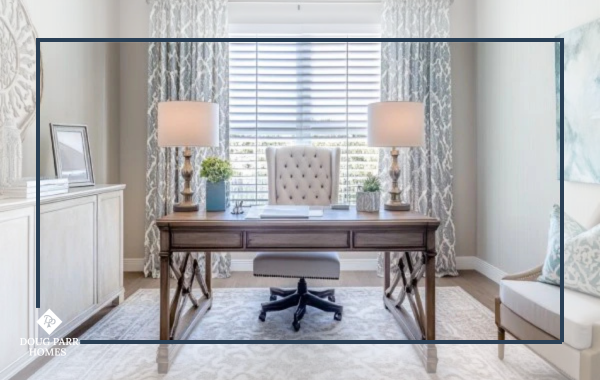 Home office with a large window, warm recessed lighting, and task lighting for an inviting workspace.