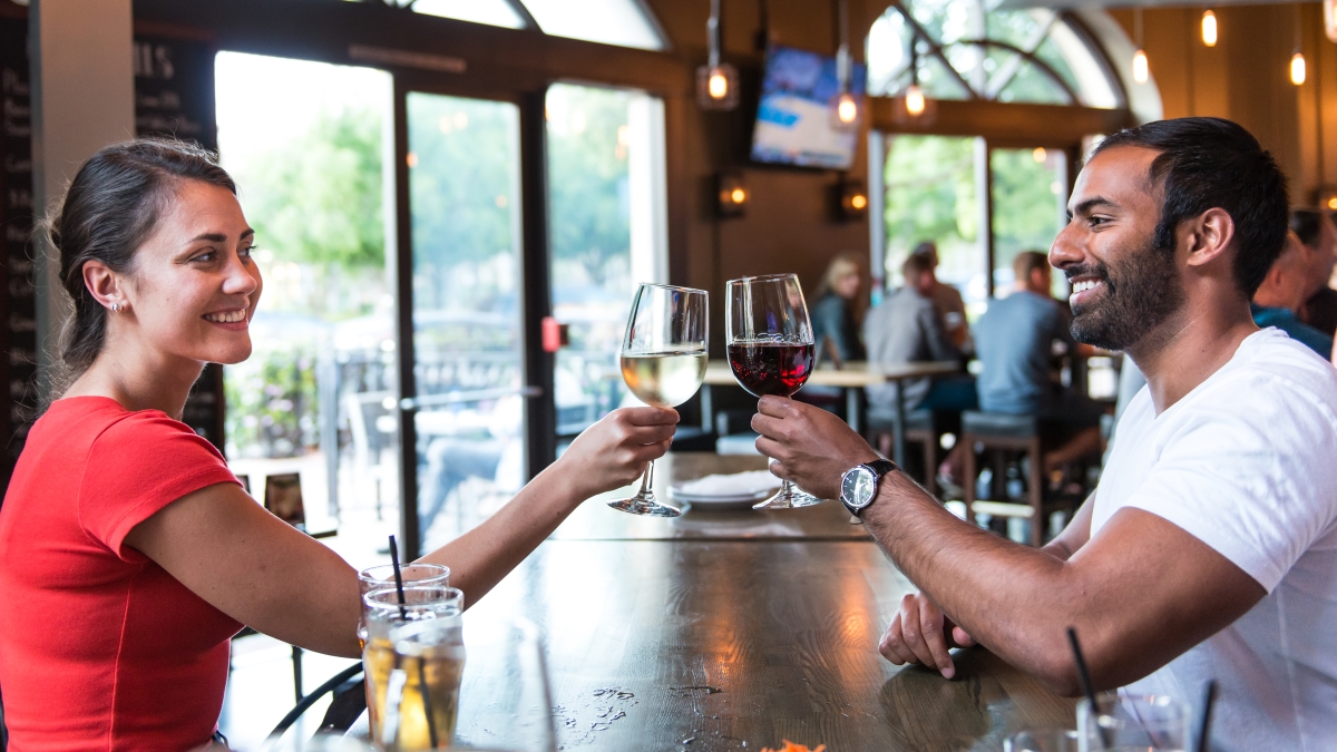 Guests-smiling-with-red-and-white-wine-gulp-playa-vista