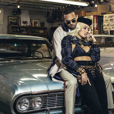 Agnez Mo and Chris Brown On A Car Agnez Mo and Chris Brown on the hood of  a car. 