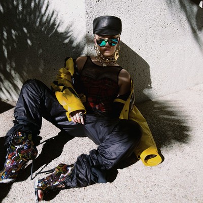 Agnez Mo in Designer Clothing  Agnez Mo in a designer hat, sunglasses, shoes, and outfit