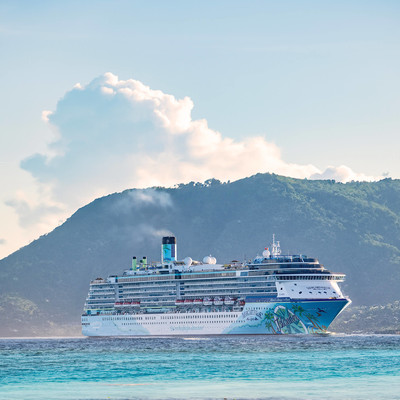Islander ship passing by a tropical mountain