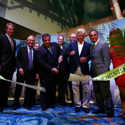 A man cuts a paper tape with scissors